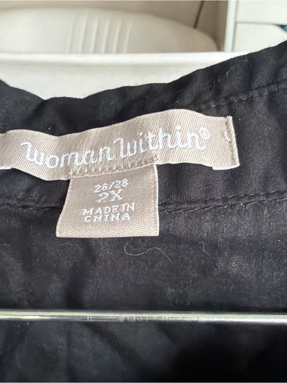 Woman within black 1/4 button down - Picture 2 of 3